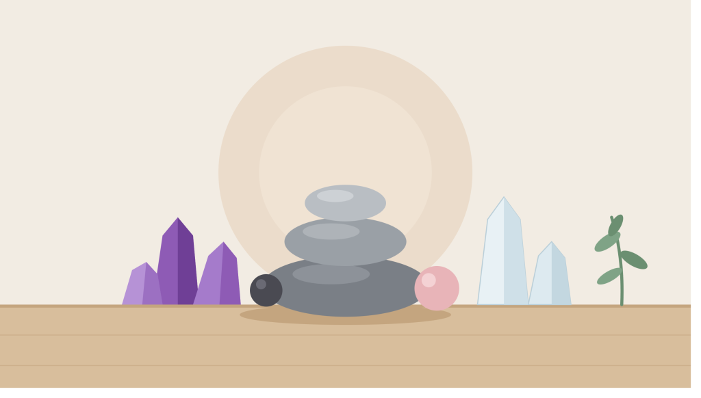 Amethyst, clear quartz and black tourmaline meditation stones arranged on a wooden tray